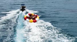 Beachgoers dumped from inflatable when it hits wake from the boat