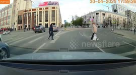 Four riders zoom over faded zebra crossing on single scooter