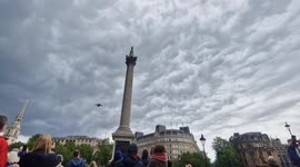 Spectators cheers as the iconic Red Arrows pass over Trafalgar Square during VE Day anniversary flypast