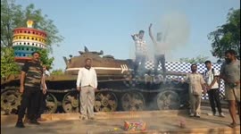 Locals in western India climb on tanks to celebrate strikes on Pakistan