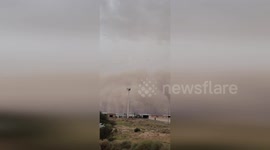 Dust storm cloud towers over homes in Saudi Arabia