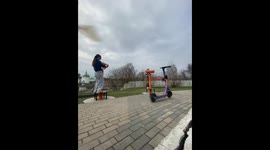 Woman startled by bee while using binocular viewer in Sergiyev Posad, Russia