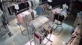 Storm batters shop and blows over racks of clothes like dominoes