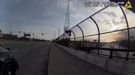 Police talk down distressed man from highway bridge in Michigan