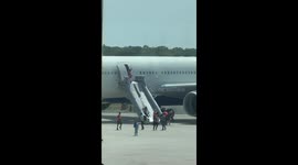 Crowd Watches Delta Plane Catch Fire From Airport Terminal