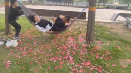 Couple topples after hammock snaps mid-swing