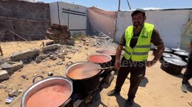 Displaced Palestinians queue for food amid deepening hunger crisis in Gaza
