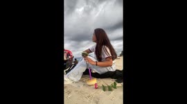Birthday girl celebrating alone on beach receives well wishes from passersby