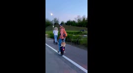 Dog wearing goggles rides electric unicycle with owner in Minsk, Belarus