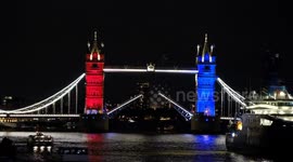 A lamp for peace sails under Tower Bridge activating an illumination to celebrate VE Day 80