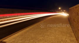 The Kings' new Highway, red tail lights trace patterns at night, Nansledan, Cornwall, UK