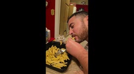 Hamster eats pasta with couple in Los Angeles, California, USA