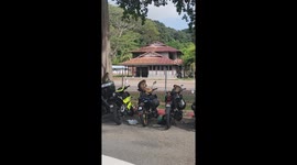 Wild monkeys sitting on motorcycles feast on found snack