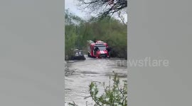 Driver plunges into rain-swollen river as car is swept away