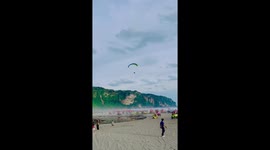 Paraglider crash lands on beach shack roof in Indonesia