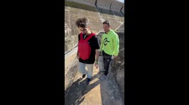 Two men slide down a concrete slope in Almería, Spain