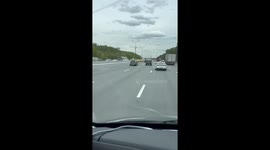 Car drives with front hood blocking windshield in Moscow, Russia