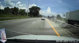 Plastic road barrier flies through the air and hits oncoming car