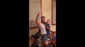 Baby laughs at German Shepherd