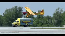 Stunt pilot lands plane on moving truck
