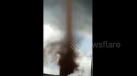 Eerie red 'tornado' roams in field in Guangdong, China