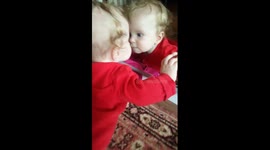 Baby is fascinated by her own reflection