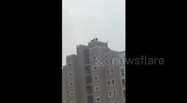 Firefighters rescue a man wanting to suicide by jumping off a high building