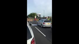 Black Lives Matter protestors hold up ambulance on motorway