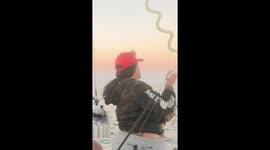Hilarious moment when squid unleashes surprise ink attack onto woman's face