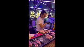 Thai food seller imitates Salt Bae as he prepares steak on market stall
