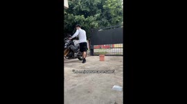 Guy Trips on Bucket While Washing Motorcycle