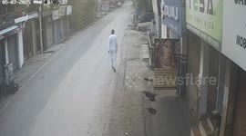 Missiles hits building in India moments after resident walks down street