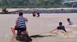 Students rescued from swollen river amid heavy rain in the Philippines