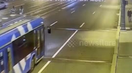 Car overtaking bus hits road worker carrying buckets of paint