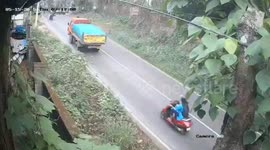 Scooter rider scrambles to avoid truck rolling backwards towards her