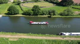 Following a canal boat as it drives down the canal