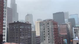 Dust storm shrouds buildings in Chicago as tornadoes sweep region