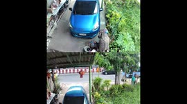 Car rolls downhill due to forgotten handbrake in Bangkok, Thailand
