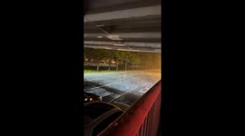 Motorists take shelter under bridge during hailstorm in Beijing, China