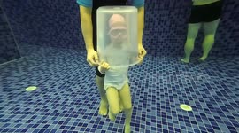 Chinese swimming coach submerges children with buckets on head to create air bubbles