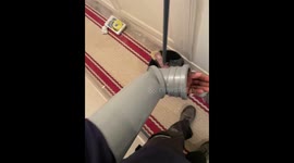 Man struggles to remove stuck PVC pipe from hand in Créteil, France