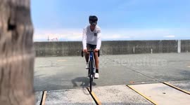 Cyclist gets his front wheel stuck in tiny gap in pavement