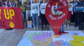 Environmental activists pour “oil” over their heads outside Shell HQ