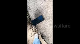 Tourist's clever prank fools internet as she pretends phone-shaped rock on mountain charged her mobile