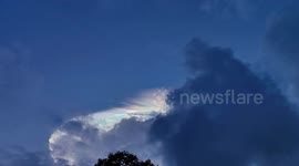 Beautiful cloud iridescence seen above homes in the Philippines