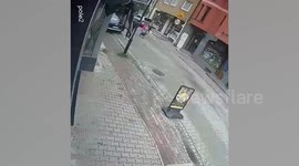 Street lamp topples onto woman after drunken man leans on it