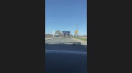 Guys Drive Under a Crop Sprayer