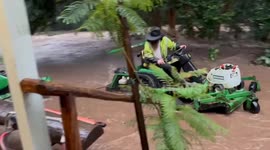 Resident takes his tractor to higher ground as flood rises in New South Wales