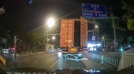 Container swings open as truck travels along road