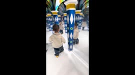 Hilarious moment toddler repeatedly crashes into glass maze panels in China